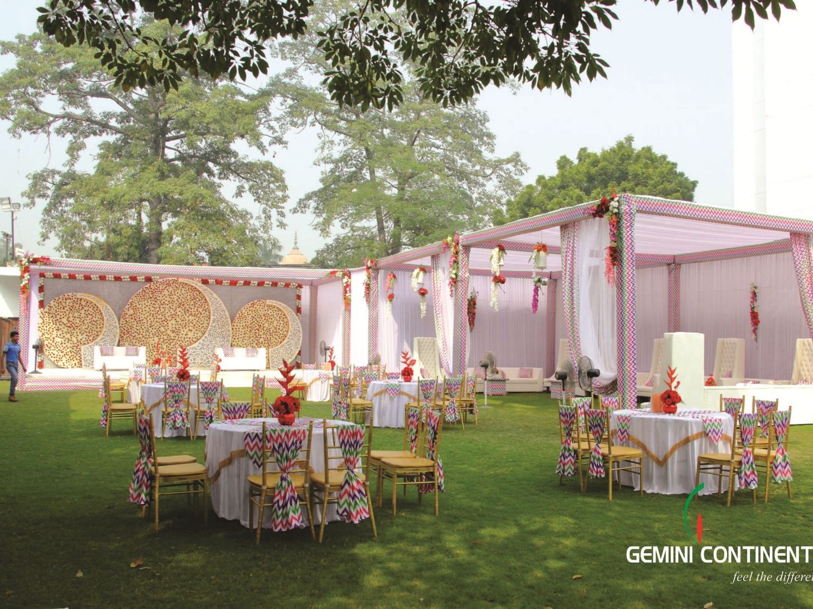 An outdoor banquet setup with round tables and floral decor at Gemini Continental, a hotel near lucknow railway station