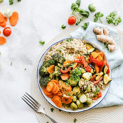 A bowl filled with nutritious carbs,  greens and vegetables.