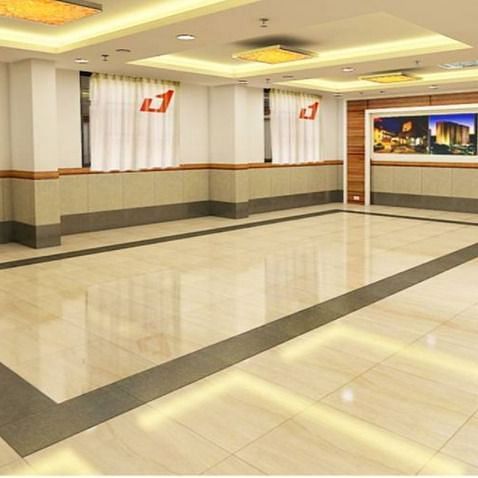 alt-text A spacious and well-lit hotel hallway leading to different rooms with pictures and branding on the walls.