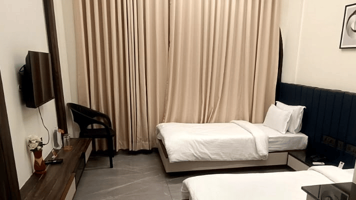 Spacious twin bedroom with modern flooring - Lords Swastik Studio, Kodinar