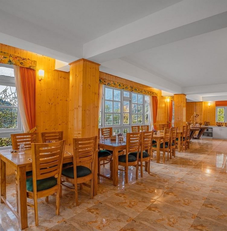 Image of a restaurant with sitting area and view of the mountain in front at Summit Gangchen Hotel, Lachen