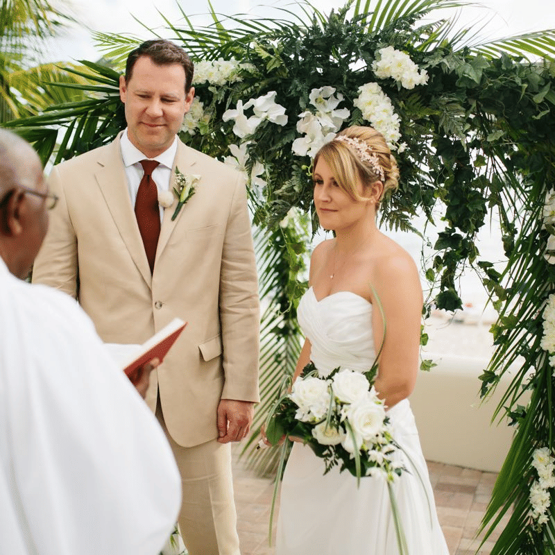 A couple getting married in the presence of the priest at The Soco Hotel, Barbados. 