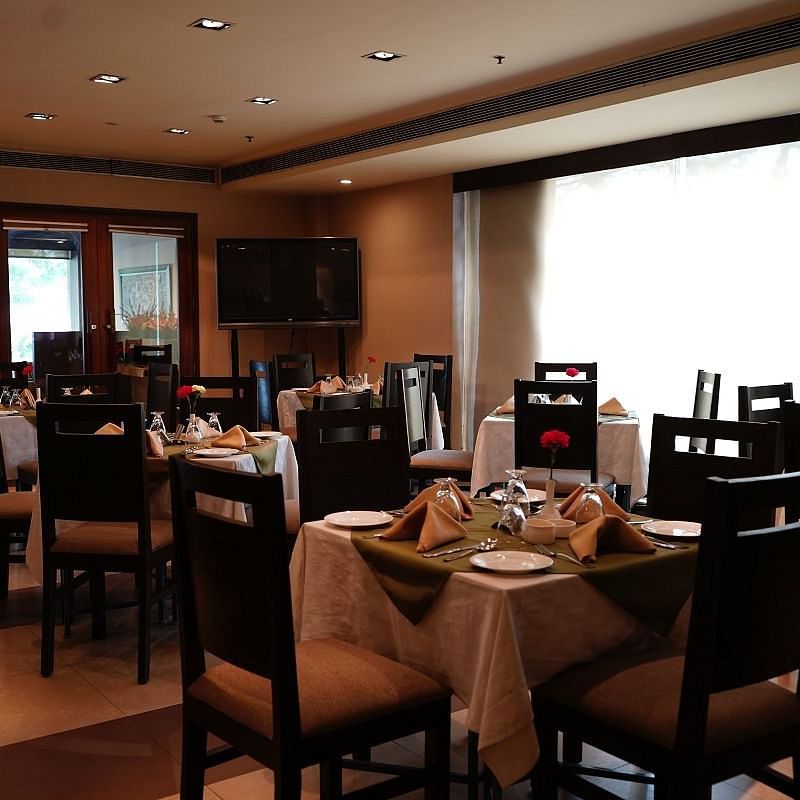 Interior of a cafe featuring elaborate seating arrangements at Shervani Nehru Place, New Delhi