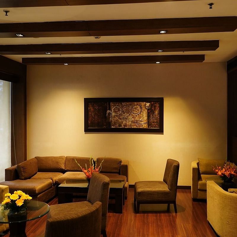 comfy sofa placed in the lounge area of Shervani Nehru Place, New Delhi