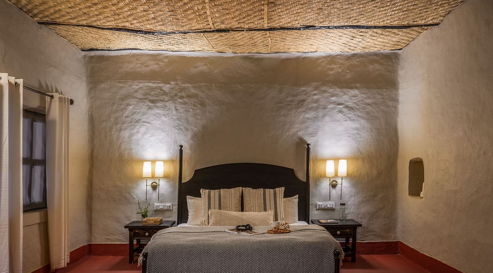 Front view of the king size bed at Mud House Suites at Saccharum Safari Lodge, Balaghat