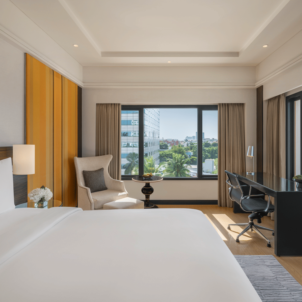 Bedroom with large window, desk, and bed at The Raintree, St. Mary’s Road.
