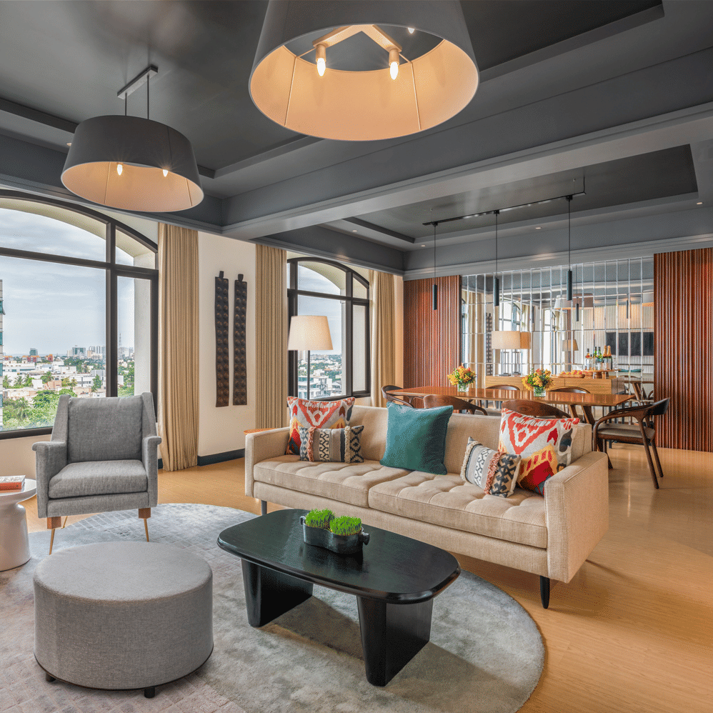 Lounge with sofas, chairs, and large windows at The Raintree, St. Mary’s Road.