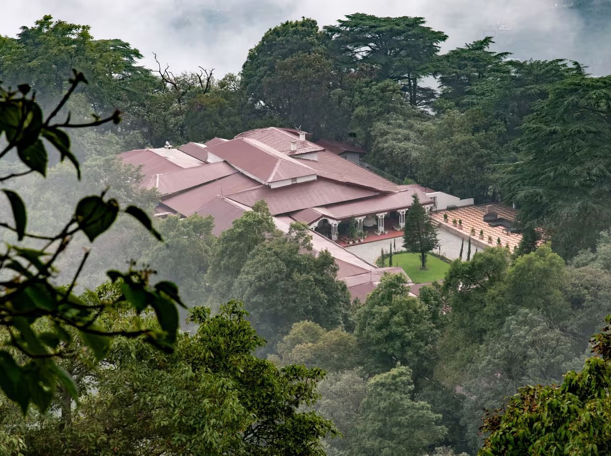 aerial view shot of The Claridges Nabha Residence in Mussoorie surrounded by lush green forest