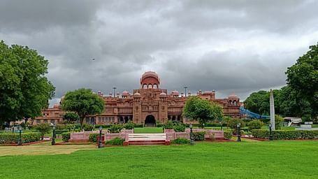 A facade image of The Laxmi Niwas Palace during a cloudy day