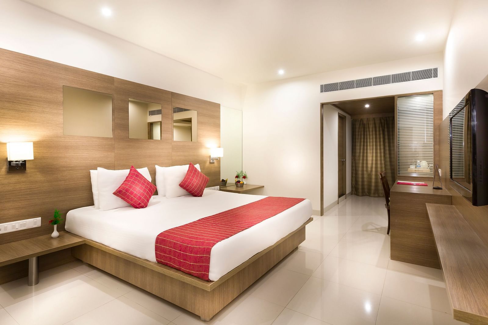 An image of a king size bed of a Deluxe Room at Regency Tiruttani by GRT Hotels.