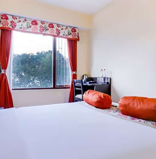 A view of a king size bed in front of TV at Summit Namnang Courtyard and Spa