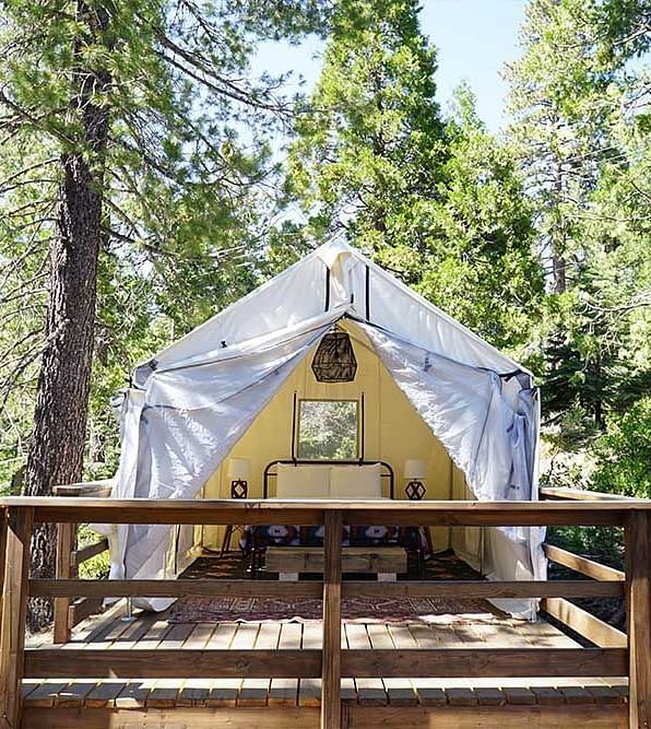 Exterior of a tent surrounded by trees at Shaver Lake Village Hotel.