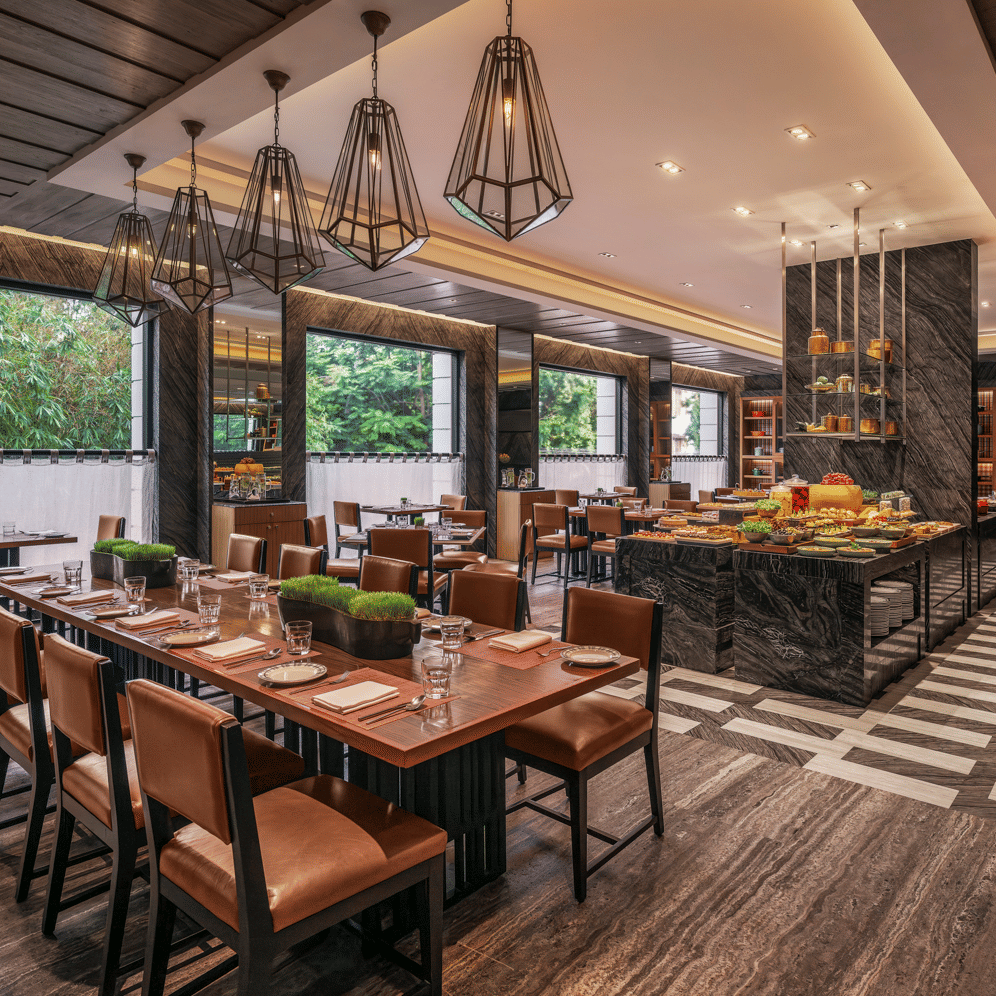 Dining area with large windows and neatly arranged tables at The Raintree, St. Mary’s Road.