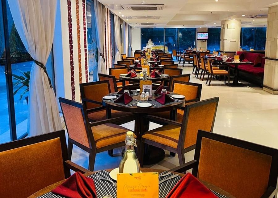A view of a restaurant interior with multiple tables and chairs arranged for guests