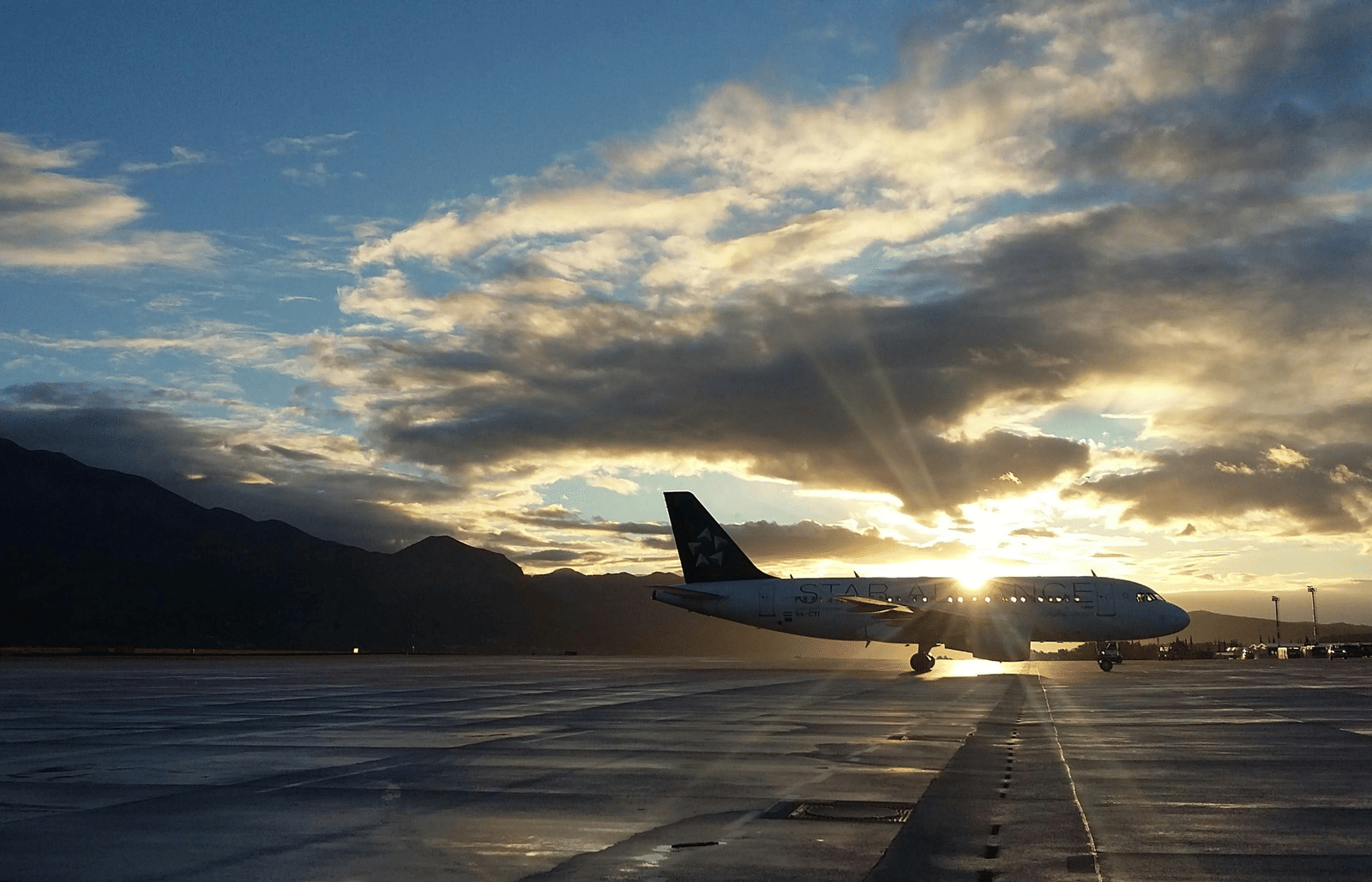 A silhouette of an aircraft parked on the runway.