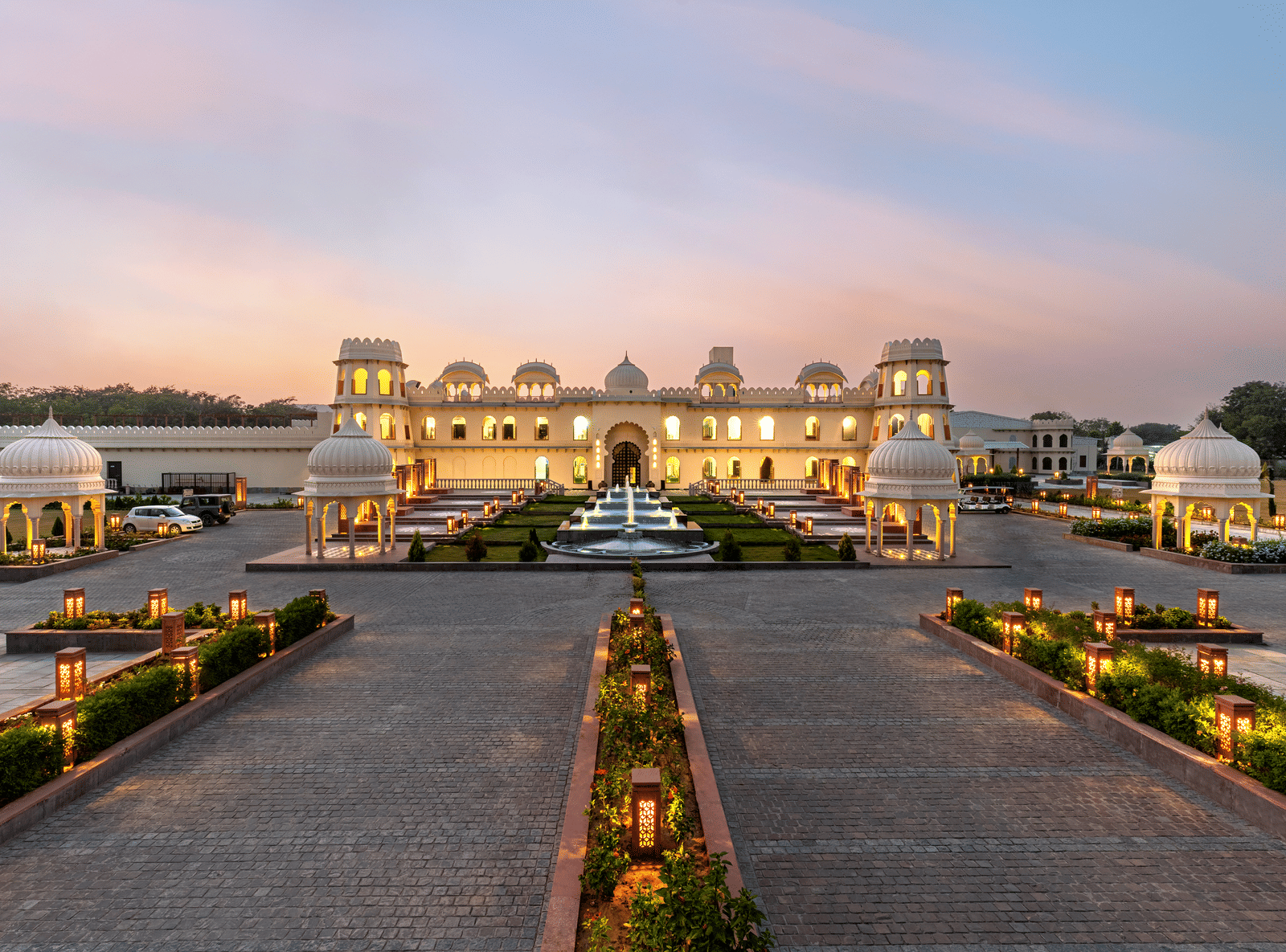 Grand outdoor wedding with palace architecture and evening lighting in Chittorgarh, Rajasthan.