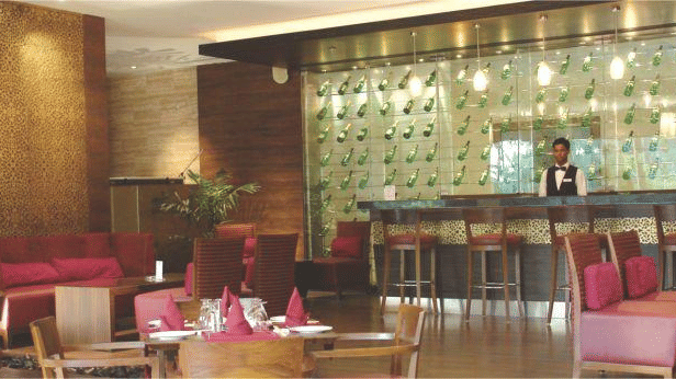 The interior of a bar with chair, tables and a bar counter.