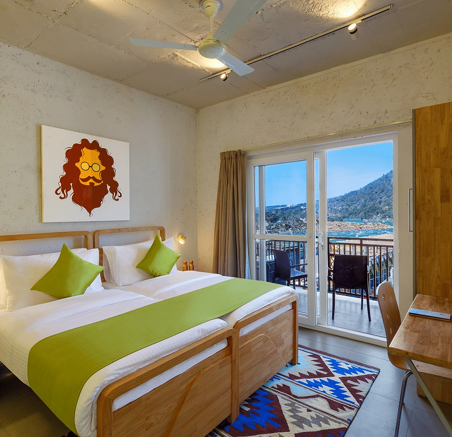 A bedroom with mountain view window at Bedzzz, Rishikesh 