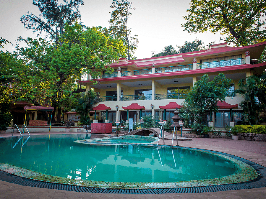 Picture of Pool with big building in the background - Adamo Resort Matheran