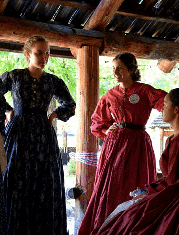 Women talking to each other in a wooden cabin - Narrow Gauge Inn - A Serenite Hotel Near Fish Camp.