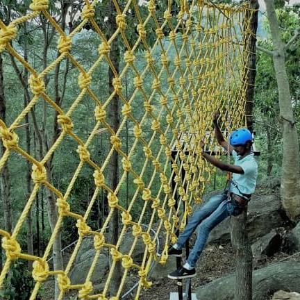 image of a man clinging to the Cargo Net with safety gear