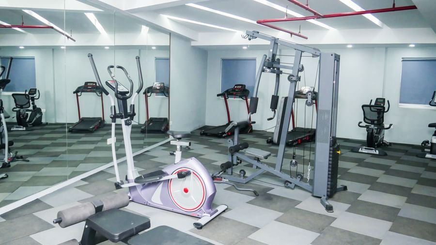 A well equipped hotel gym with various exercise machines and a clean floor, ready for a workout at Shilton Dee Cee.