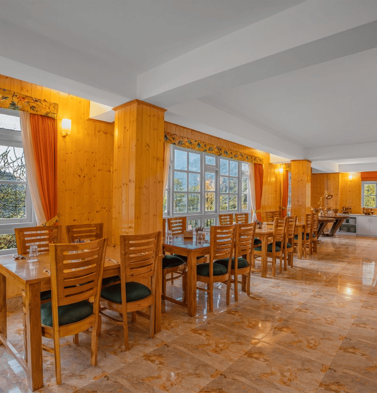 Image of a restaurant with sitting area and view of the mountain in front at Summit Gangchen Hotel, Lachen