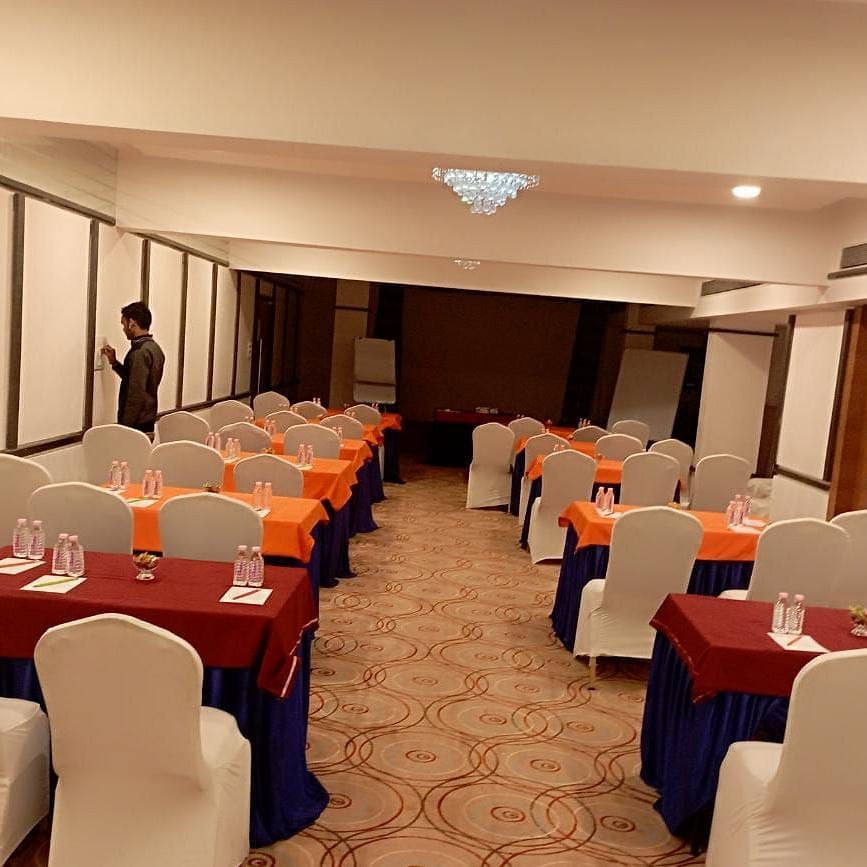 Banquet hall at Rang Lords Inn, with neatly arranged tables and chairs