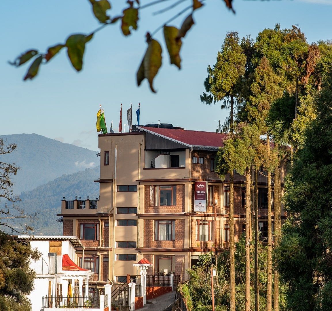Facade of Summit Sherpa Mountain Hotel & Spa, Kalimpong with a mountain range in the background