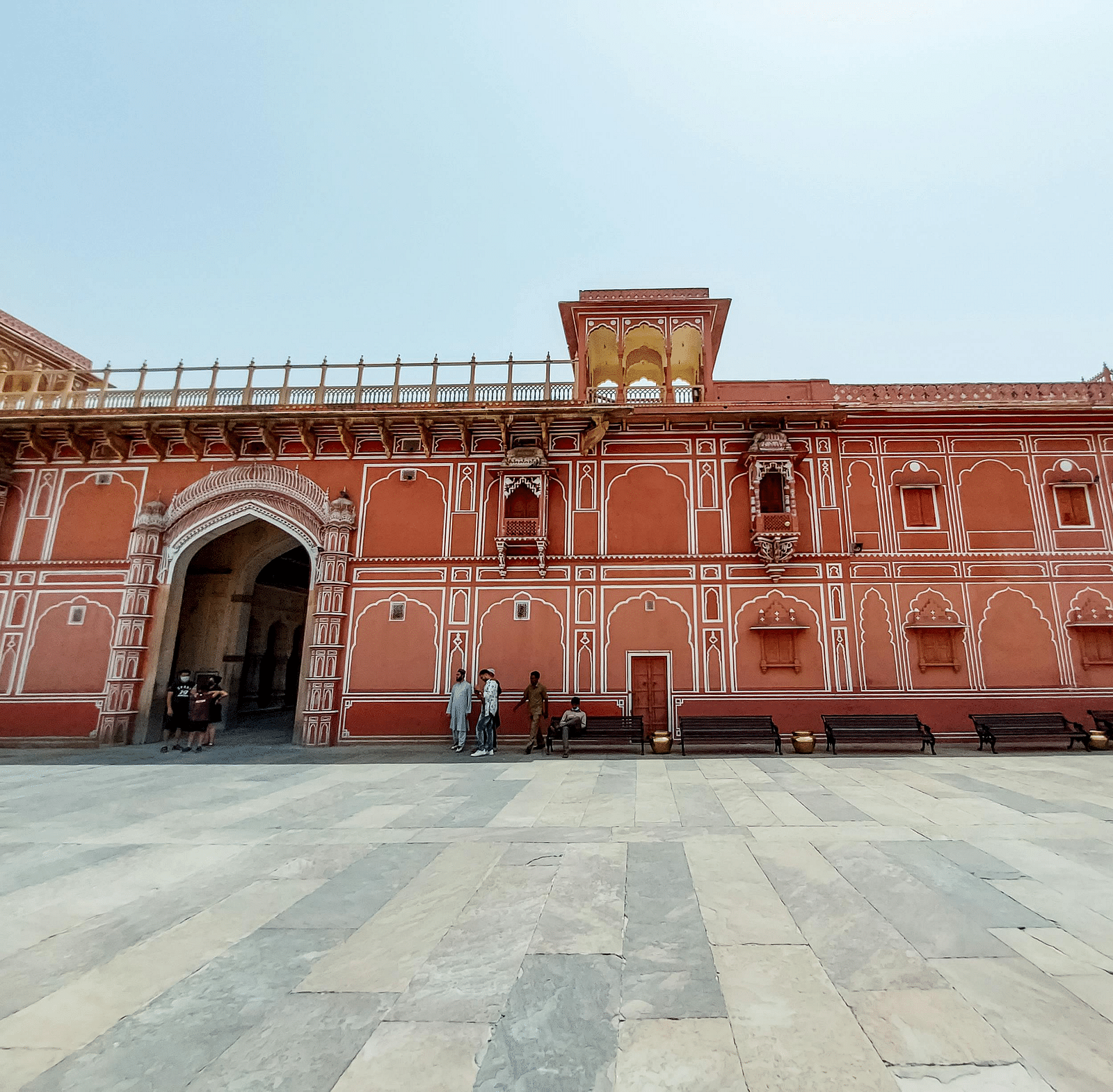 facade image of the city palace in jaipur with a clear backdrop of a light blue sky