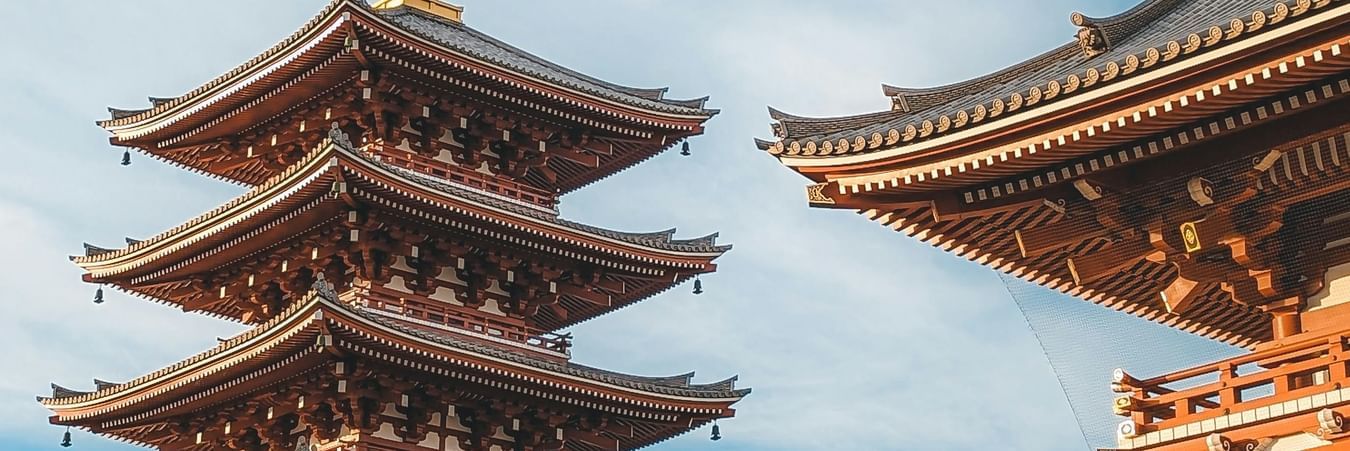 Traditional pagoda temple architecture with multiple tiers against cloudy sky showcasing Asian design