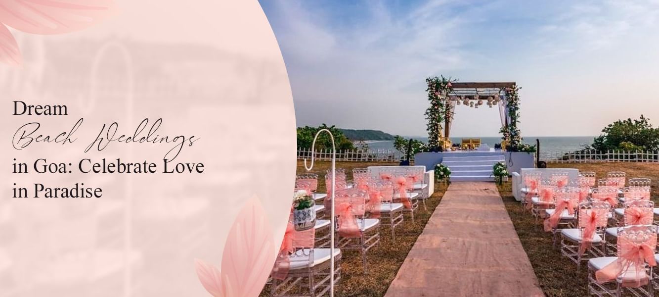 Dream beach wedding setup in Goa with a floral mandap on a raised platform, overlooking the ocean, and clear chairs with pink accents.