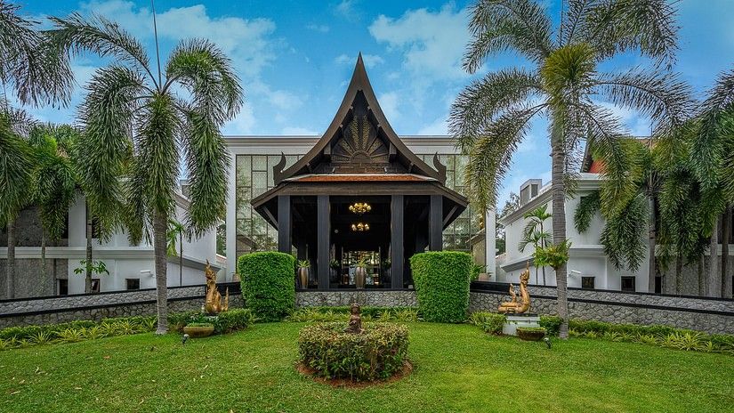 image of the entrance with a serene green lawn in the foreground - Maikhao Dream Villa Resort & Spa, Phuket