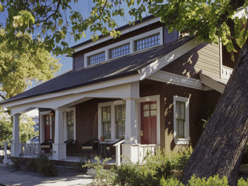 A view of Main Street Suites entrance of Tallman Hotel with a large tree trunk nearby