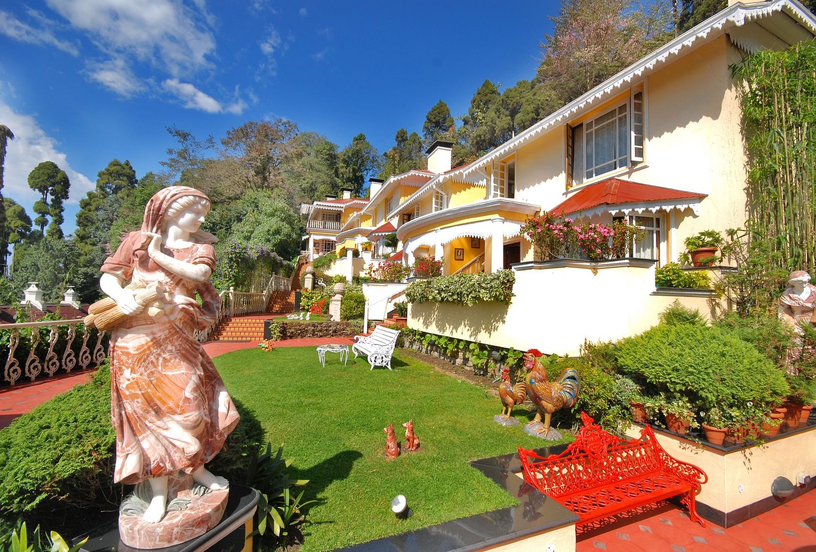 a statue in the lawn area  -Mayfair Hill Resort, Darjeeling