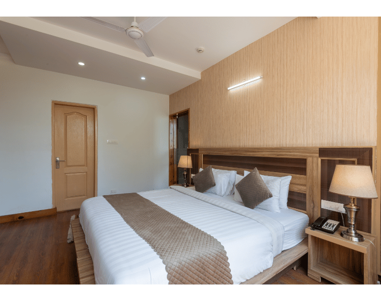Focused view of the King size bed and bedside tables in the Family Suite of DLS Hotel Shiva Sanctuary & Spa in Dharamshala.