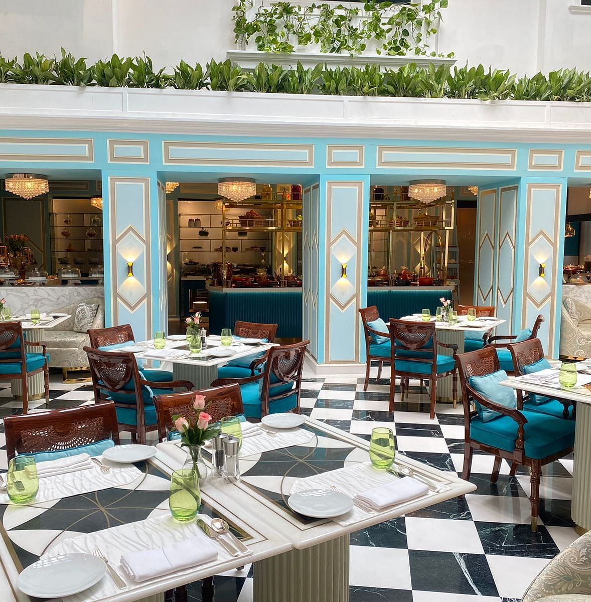 interiors of a dining restaurant with comfortable chairs and tables with cutlery and napkins