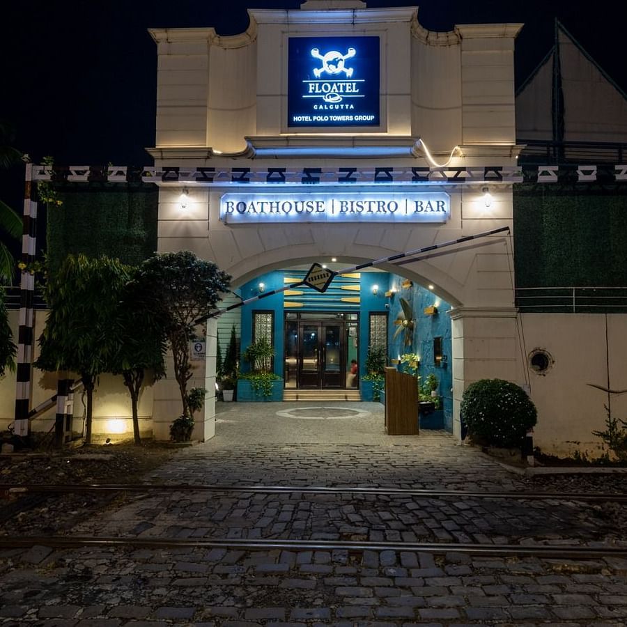 A nighttime view of Floatel's entrance with its sign illuminated and ambient lighting.