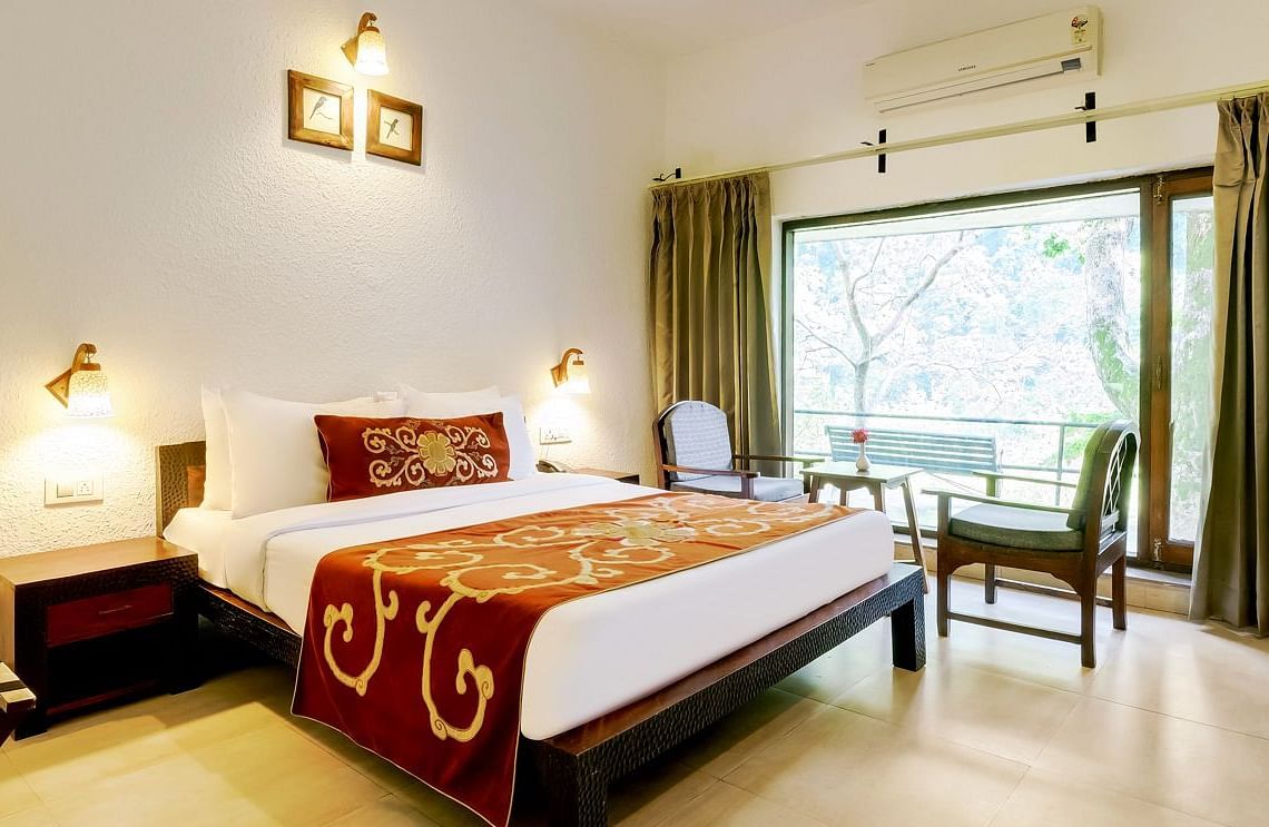 Image of a room with bed and large windows at Summit By The Ganges Beach Resort & Spa, Rishikesh