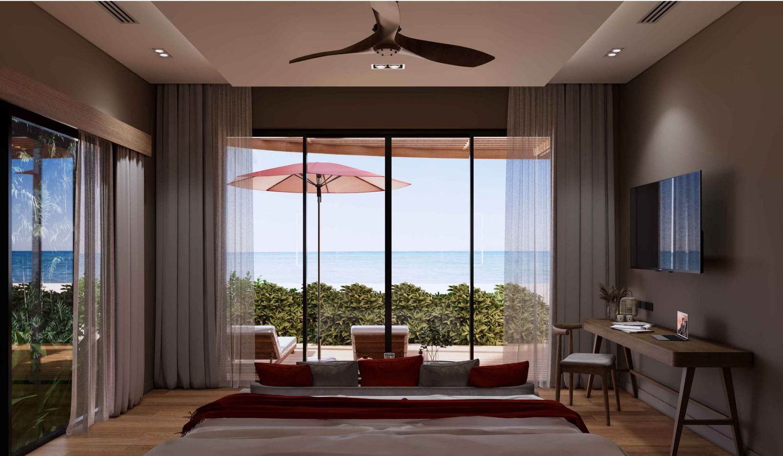 A bedroom with large glass doors opening to a private patio, red umbrella, sunbeds, and stunning ocean view at Ramada Resort by Wyndham Khao Lak.