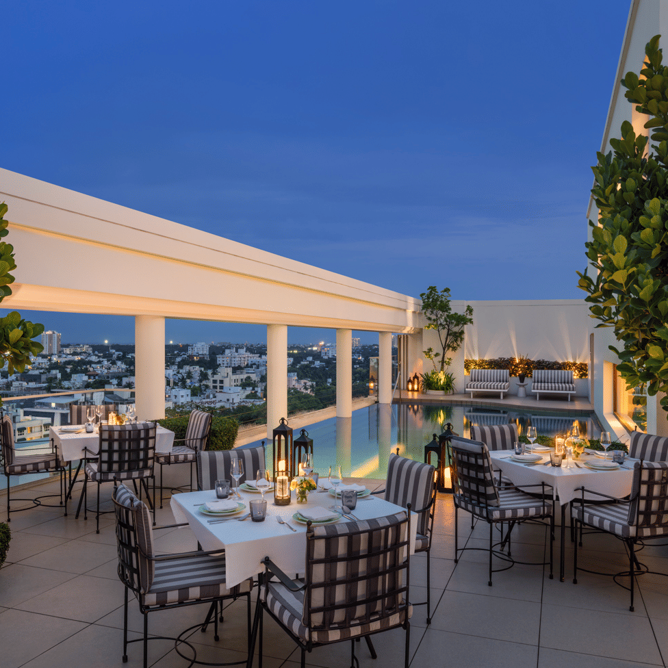 Outdoor terrace with tables, chairs, and plants at The Raintree, St. Mary’s Road.