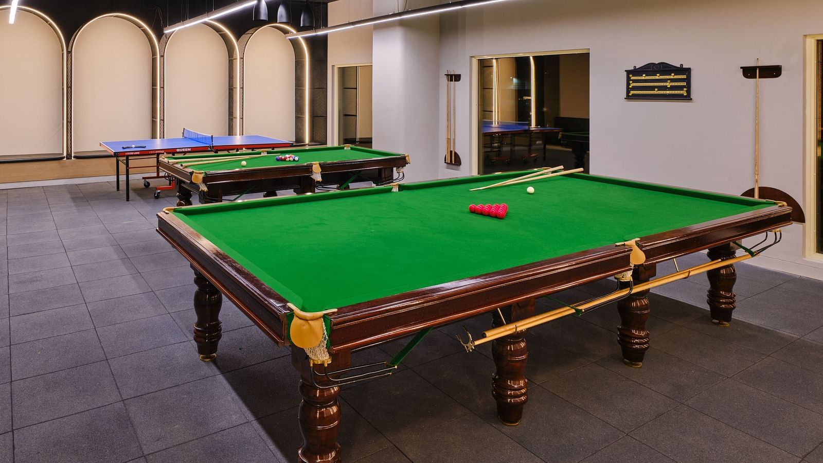 Image of Relay which is the game room at Swosti Premium Beach Resorts in Puri featuring pool tables with assorted balls on them