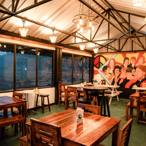 A warmly lit dining space in Woodstock resort, with view of the outdoors 