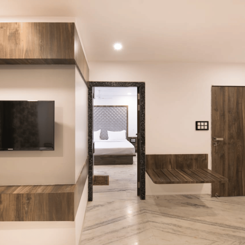 The living space of royal suite by sanmukh with its wooden interior and clean ambience.