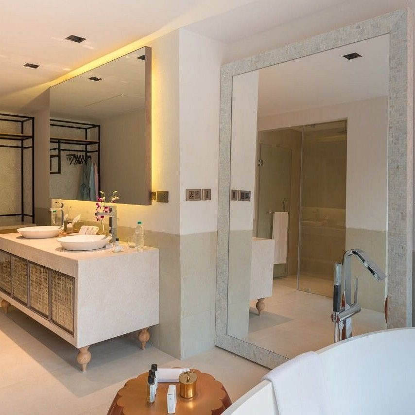 alt-text Immaculate bathroom interiors with two large mirrors and toiletries