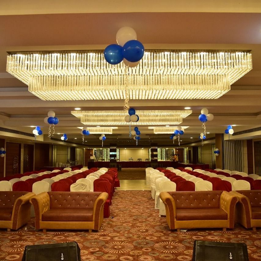 A banquet hall at Rang Lords Inn, with theatre style seating and decorated with blue and white balloons