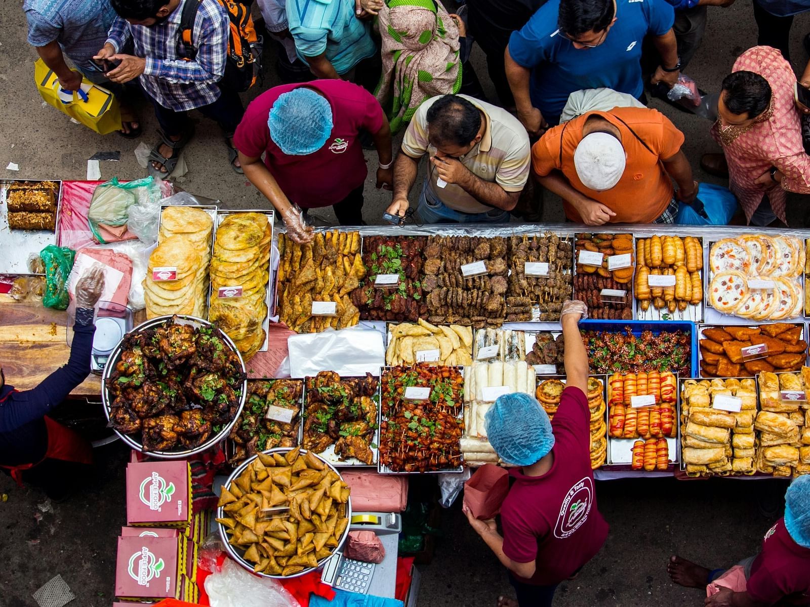A top-view of people shopping in a market.