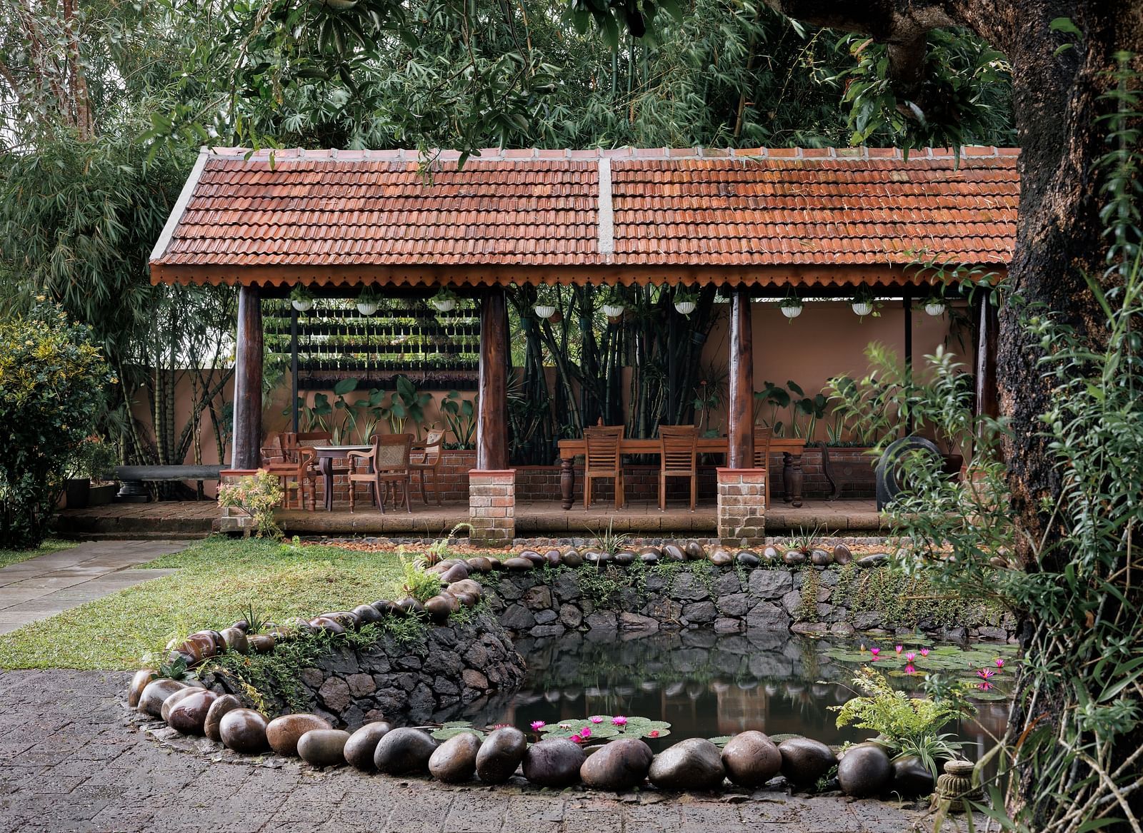 A facade image showcasing the pond at BluSalzz Villas - Muhamma Resort, Alleppey and the outdoor seating area of the restaurant