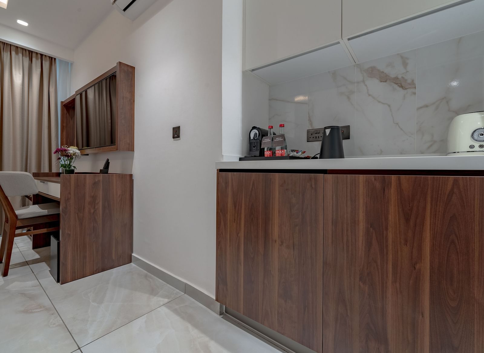 Standard Room with wooden desk, minibar, kettle, toaster, marble backsplash, and elegant lighting. - The Pelican Hotel, Accra