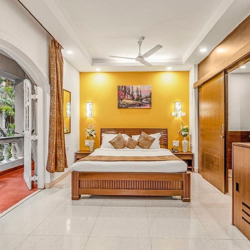 Image of Junior Suite with a bed and an attached balcony at Calux Joia Do Mar Resort, Goa.